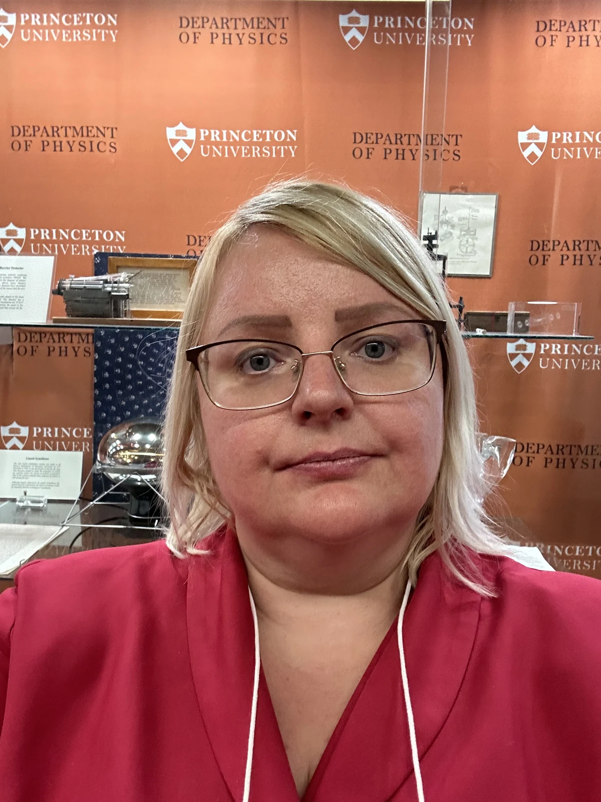 Julie in front of a Princeton University Department of Physics display