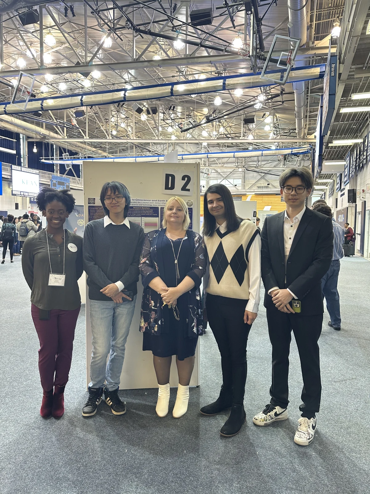 Julie and four students beside research posters at Kean Research Days